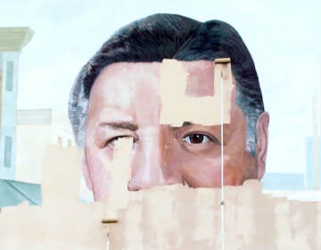 The Frank Rizzo mural partially covered with beige and white paint