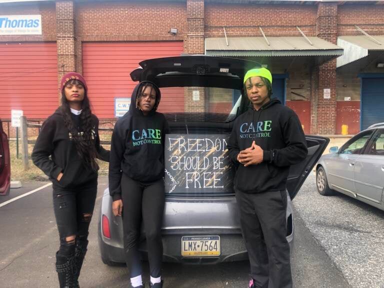 Maxine Morris, Luna Jung, and Andre Simms, organizers from Care, not Control, preparing to join the caravan protesting the conditions inside Philly jails