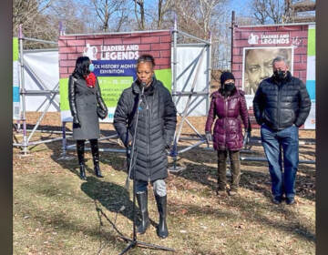 Latoya Hackney, wife of Otis Hackney, accepts the honor Saturday during Smith Memorial Playground’s program in East Fairmount Park. Frances Hoover, Smith Playground executive director, City Councilmember Helen Gym and Mayor Jim Kenney were also on hand for the 'Leaders and Legends of Philadelphia' program. (O.J. Spivey/The Philadelphia Tribune)