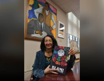 Curator of the Charles L. Blockson Afro-American Collection Diane Turner holds a copy of the graphic novel BLAM! (Abdul Sulayman / The Philadelphia Tribune)