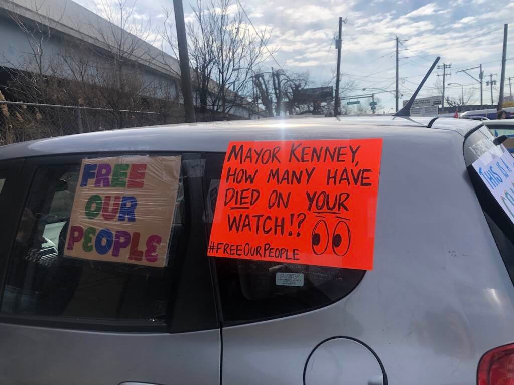 Signs taped to a car joining the caravan in Northeast Philly.