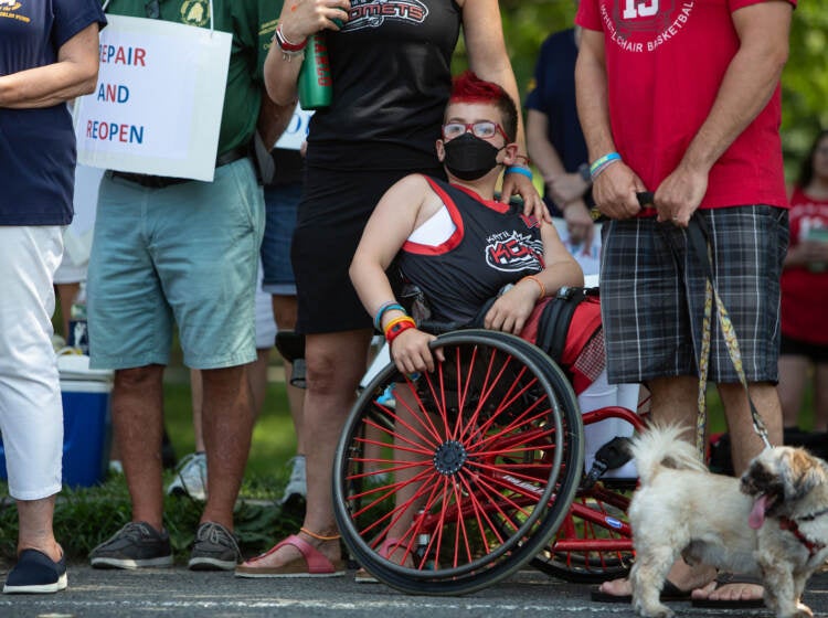 A Katie's Komets player sits in a wheelchair at a protest