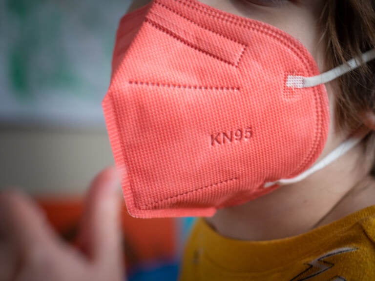 A child wears a KN95 protective mask for kids arranged in Hastings-on-Hudson, New York, U.S., on Thursday, Jan. 13, 2022. (Tiffany Hagler-Geard/Bloomberg via Getty Images)