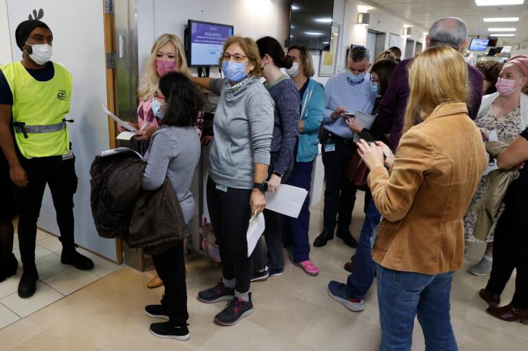 Staff volunteers queue to receive a fourth dose of the Pfizer COVID-19 vaccine at Sheba Medical Center in Israel on Dec. 27, 2021, as the hospital conducted a trial of a fourth jab of the vaccine. (Jack Guez/AFP via Getty Images)
