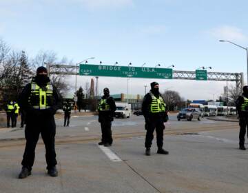 Police from London, Ontario, block protesters from the Ambassador Bridge on Saturday.
(Jeff Kowalsky/AFP via Getty Images)