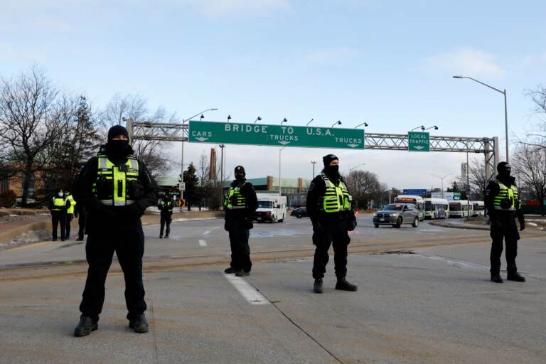 Police from London, Ontario, block protesters from the Ambassador Bridge on Saturday.
(Jeff Kowalsky/AFP via Getty Images)