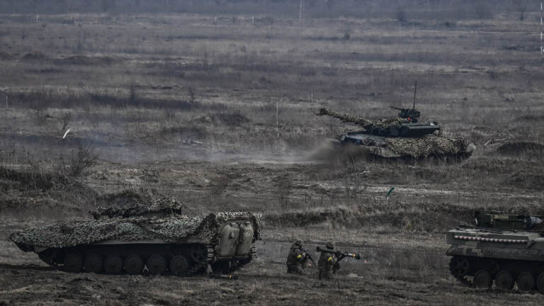 Ukrainian troops take part in a military drill outside the city of Rivne on February 16, 2022. (Photo by ARIS MESSINIS/AFP via Getty Images)