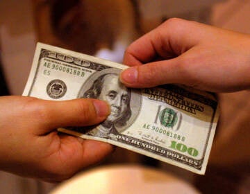 A shopper pays cash for sales merchandise on Dec. 26, 2000 in Austin, Texas. The Federal Reserve is considering whether to adopt a digital version of the dollar, in what would amount to a fundamental rethink of our national currency. (Joe Raedle/Getty Images)