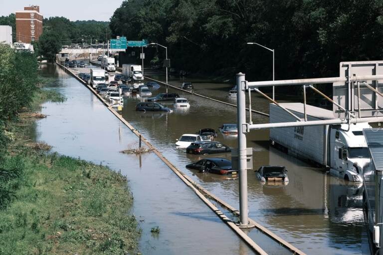 Cars sit abandoned on the flooded Major Deegan Expressway