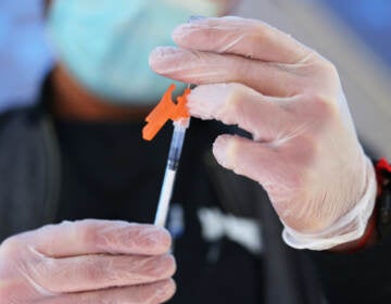 A medical staff member prepares a Pfizer-BioNTech COVID-19 vaccine