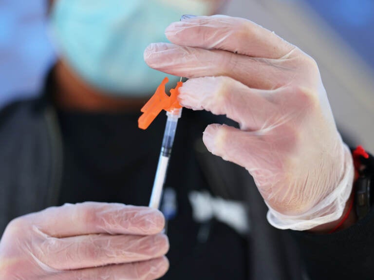 A medical staff member prepares a Pfizer-BioNTech COVID-19 vaccine