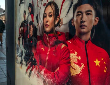 An ad for Chinese sportswear company shows American-born freestyle skiing gold medalist Eileen Gu, or Gu Ailing and other athletes competing for China at the Beijing 2022 Winter Olympics on a street on last week in Beijing. (Kevin Frayer/Getty Images)