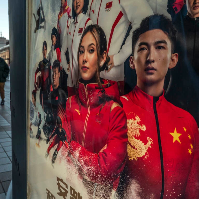 An ad for Chinese sportswear company shows American-born freestyle skiing gold medalist Eileen Gu, or Gu Ailing and other athletes competing for China at the Beijing 2022 Winter Olympics on a street on last week in Beijing. An ad for Chinese sportswear company shows American-born freestyle skiing gold medalist Eileen Gu, or Gu Ailing and other athletes competing for China at the Beijing 2022 Winter Olympics on a street on last week in Beijing. (Kevin Frayer/Getty Images)