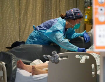 Estella Wilmarth tends to a patient in the acute care unit