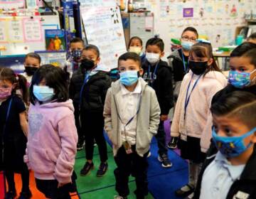 Kindergarteners wear masks while listening to their teacher amid the COVID-19 pandemic at Washington Elementary School Wednesday, Jan. 12, 2022 (AP Photo/Marcio Jose Sanchez)