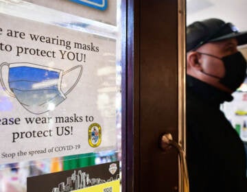 A man wears his mask as he walks past a sign posted on a storefront reminding people to wear masks, on February 25, 2022 in Los Angeles. Los Angeles ends its indoor mask mandate on February 25 for fully vaccinated people with proof of vaccination. Masks are still required for unvaccinated people or those who cannot show proof of a negative test.
(rederic J. Brown/AFP via Getty Images)