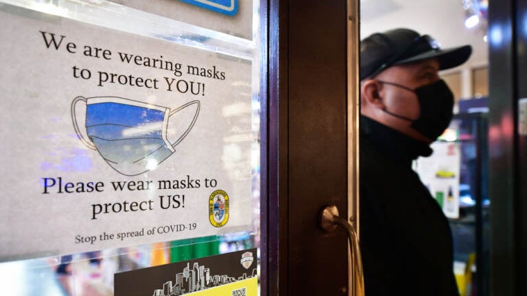 A man wears his mask as he walks past a sign posted on a storefront reminding people to wear masks, on February 25, 2022 in Los Angeles. Los Angeles ends its indoor mask mandate on February 25 for fully vaccinated people with proof of vaccination. Masks are still required for unvaccinated people or those who cannot show proof of a negative test.
(rederic J. Brown/AFP via Getty Images)