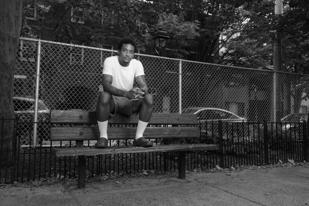 Mike White is seen sitting on top of a park bench in Philly