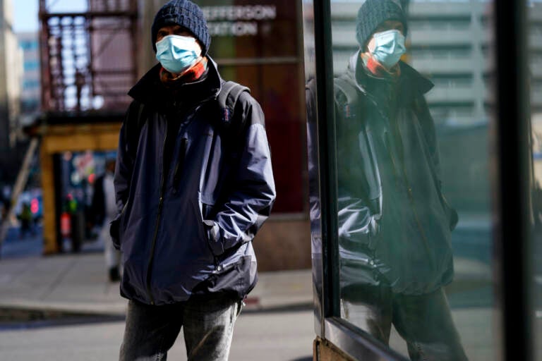 A person wearing a face mask walks in Philadelphia