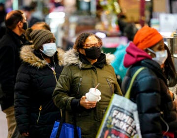 Customers wearing face masks shop at the Reading Terminal Market