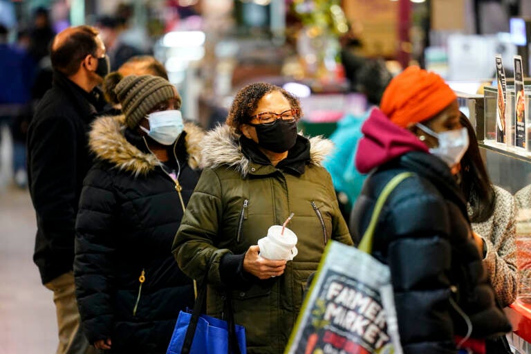 Customers wearing face masks shop at the Reading Terminal Market