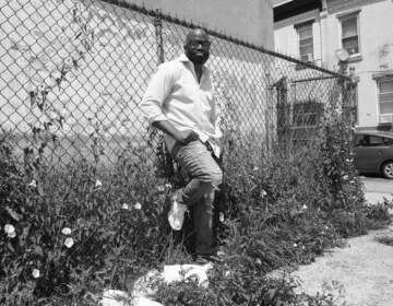 Sadiq Sellers leans against a fence in Philly