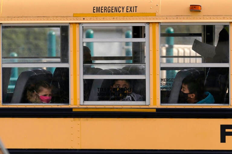 Elementary school students are pictured on a school bus