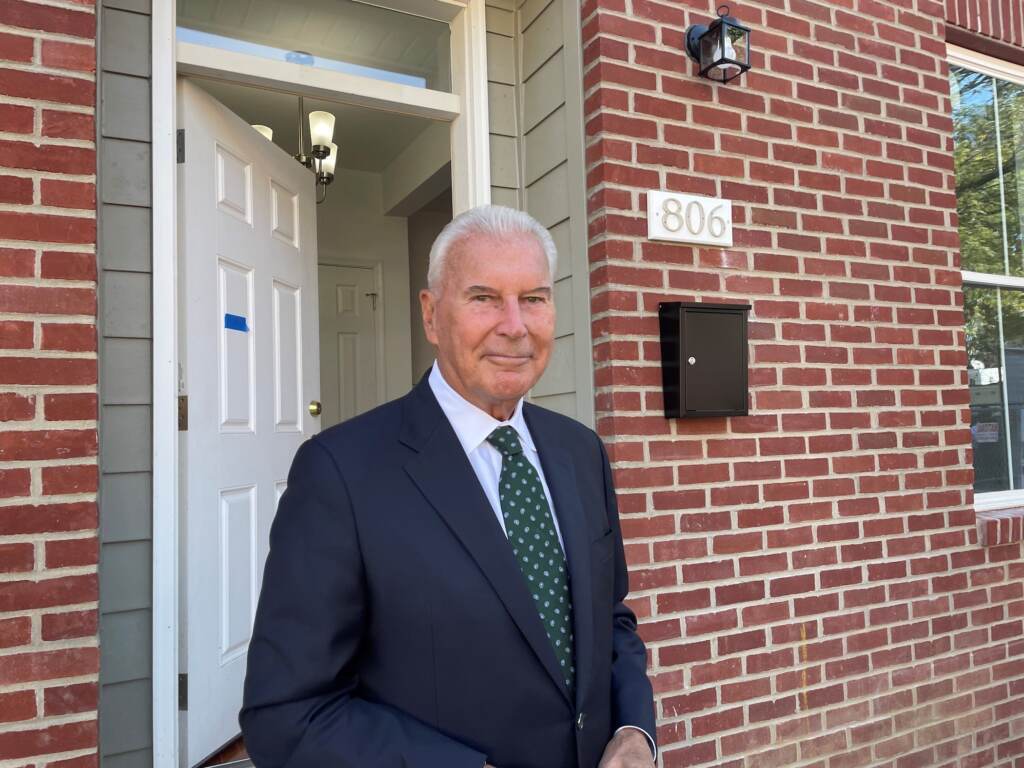 Mayor Mike Purzycki stands outside a new home build last year on Bennett Street. He says it's time to go big. (Cris Barrish/WHYY)