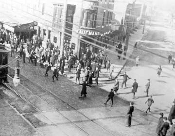 Protesters stoning a trolley car attempting to break a 1910 strike