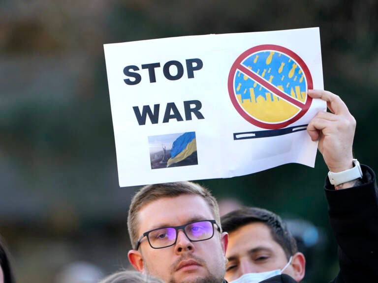 A protester holds up a sign that says 