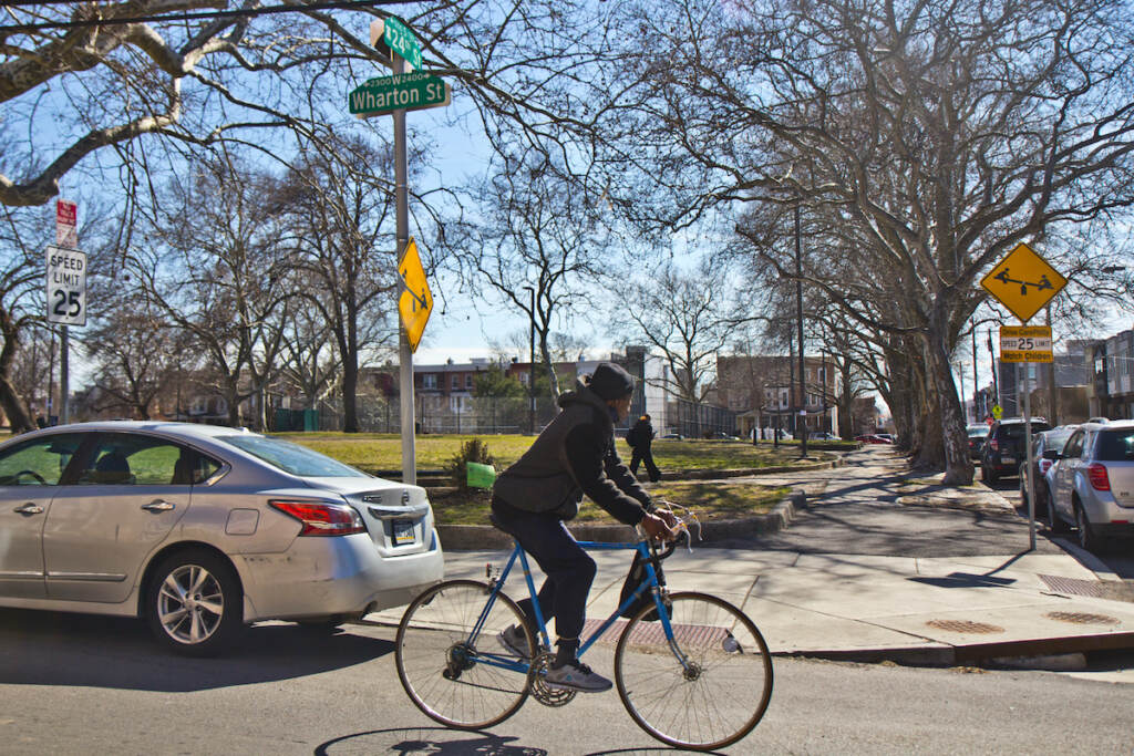 A cyclist rides sown South 24th Street