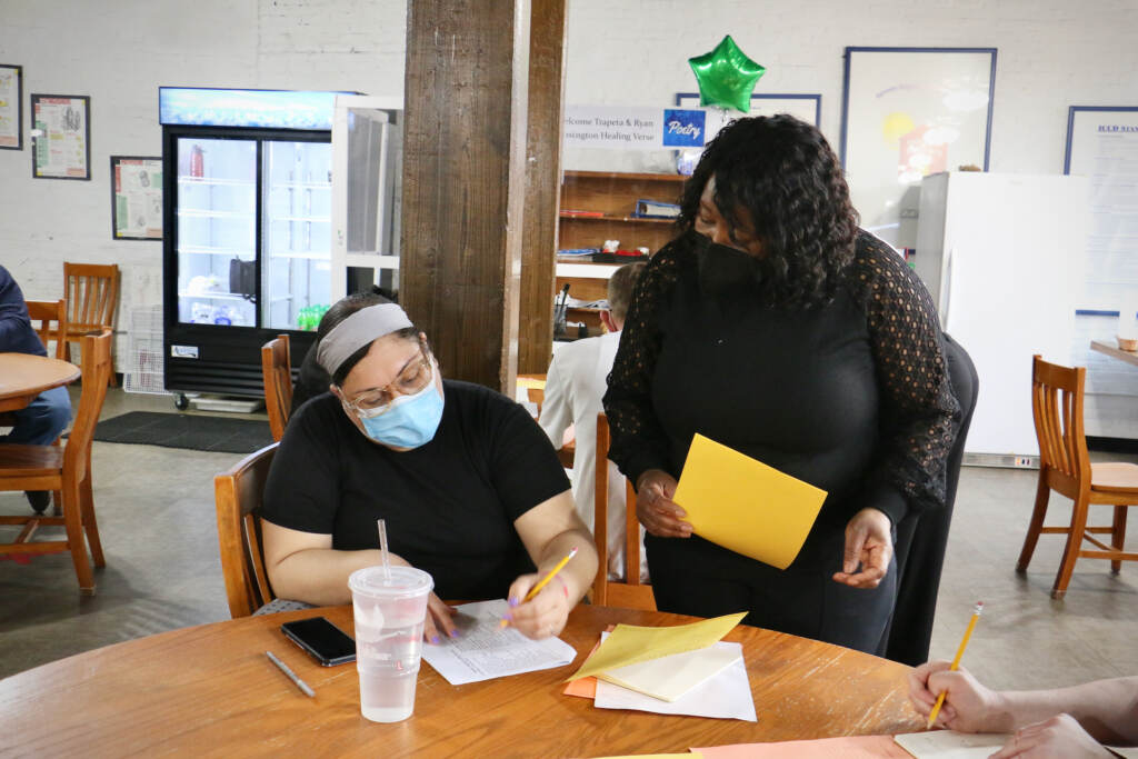 Former Philadelphia Poet Laureate Trapeta Mayson works with Amaryllis Ruiz durijg a poetry workshop at the Open Door Clubhouse in Kensington