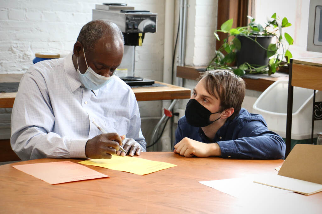 Ryan Strand Greenberg (right) works with Cary Gramby during a poetry workshop at the Open Door Clubhouse in Kensington