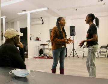 Playwright and director Bilal Islam watches a rehearsal of Childhoodslost Chronicles. (Emma Lee/WHYY)