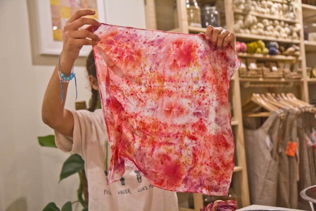 A workshop participant unwraps their fabric