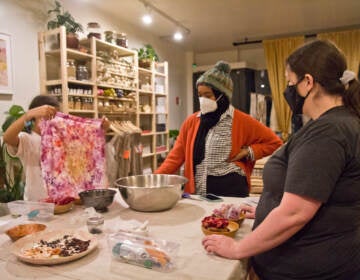 People participate in a fabric dyeing workshop at Modest Transitions
