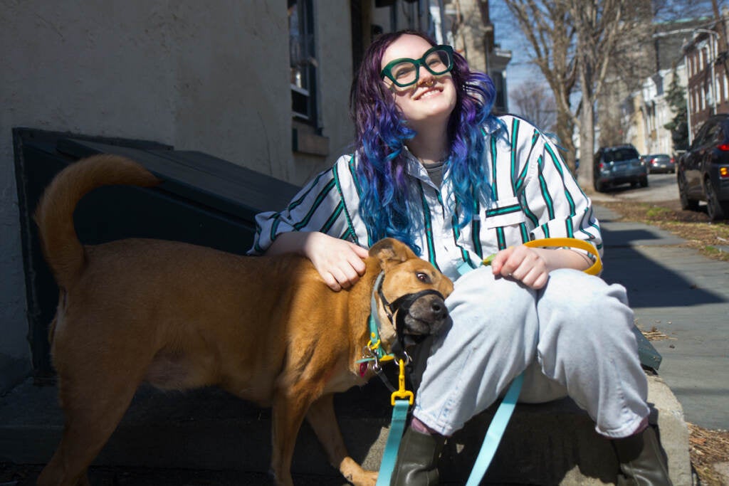 Scarlett DeLorme cuddles her dog, Winnie, in Philadelphia