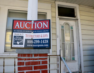 A home at 58 West Pitman Street in Penns Grove, with an auction sign in front of it