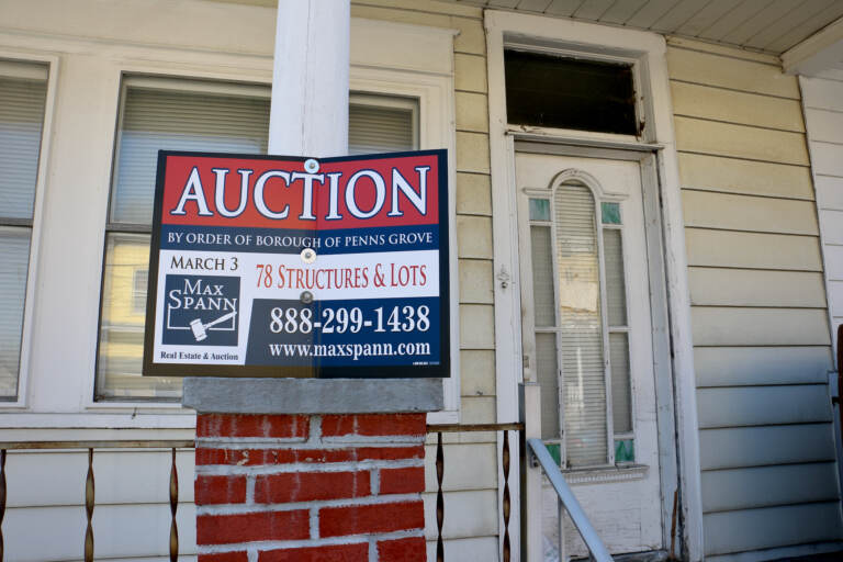 A home at 58 West Pitman Street in Penns Grove, with an auction sign in front of it
