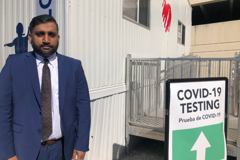 Azmat Husain stands at a COVID-19 testing site