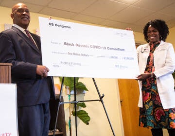 Dr. Ala Stanford (right) accepted part of $3 million in funding from Community Project Funding from Congressman Dwight Evans (left) at the Center for Health Equity on March 28, 2022. (Kimberly Paynter/WHYY)