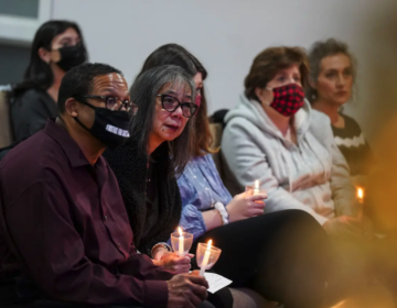 Gareth Hall, left, and his wife Fe Hall, right, look on during a vigil for their late son Christian Hall in December. Their lawsuit claims troopers used excessive force, killing Hall as he tried to surrender and after they said they would not shoot him. (Matt Smith for Spotlight PA)