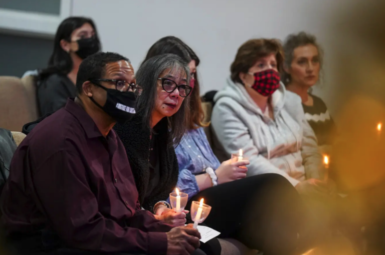 Gareth Hall, left, and his wife Fe Hall, right, look on during a vigil for their late son Christian Hall in December. Their lawsuit claims troopers used excessive force, killing Hall as he tried to surrender and after they said they would not shoot him. (Matt Smith for Spotlight PA)