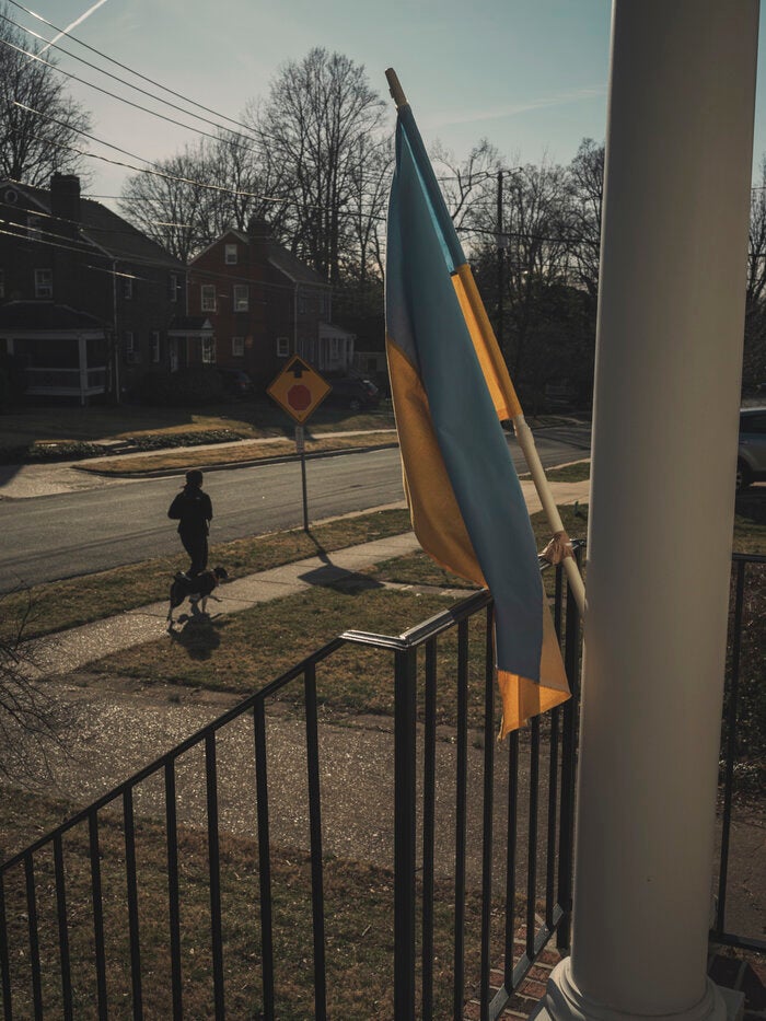 A Ukraine flag is hung outside a home