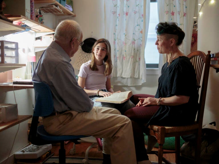 Nomi Kline Solmeson prepares for her bat mitzvah, reading the Torah in her bedroom with her grandfather, Rabbi David Kline, and her aunt Shira Kline.