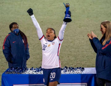 U.S. forward Catarina Macario holds up the SheBelieves Cup MVP trophy after the team's 5-0 victory over Iceland in a soccer match Wednesday, Feb. 23, 2022, in Frisco, Texas