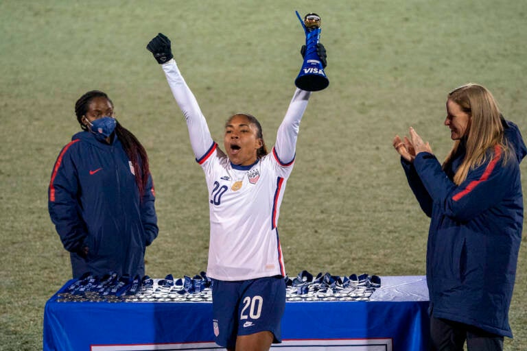 U.S. forward Catarina Macario holds up the SheBelieves Cup MVP trophy after the team's 5-0 victory over Iceland in a soccer match Wednesday, Feb. 23, 2022, in Frisco, Texas