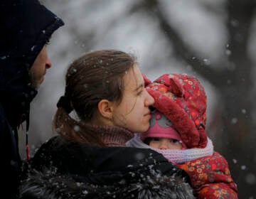 A woman fleeing the conflict from neighbouring Ukraine holds her baby at the Romanian-Ukrainian border, in Siret, Romania, Thursday, March 3, 2022. The number of people sent fleeing Ukraine by Russia's invasion topped 1 million on Wednesday, the swiftest refugee exodus this century, the United Nations said.. (AP Photo/Andreea Alexandru)