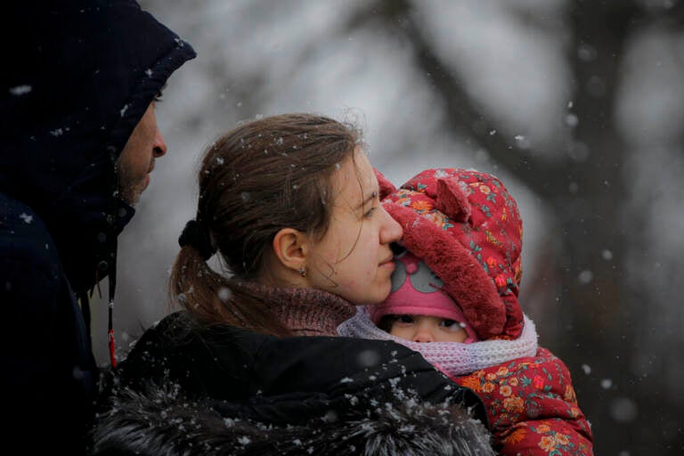 A woman fleeing the conflict from neighbouring Ukraine holds her baby at the Romanian-Ukrainian border, in Siret, Romania, Thursday, March 3, 2022. The number of people sent fleeing Ukraine by Russia's invasion topped 1 million on Wednesday, the swiftest refugee exodus this century, the United Nations said.. (AP Photo/Andreea Alexandru)