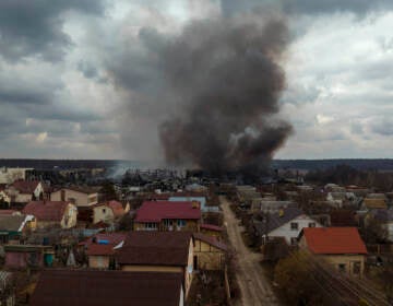 A factory and a store burn after being bombarded in Irpin, on the outskirts of Kyiv, Ukraine, Sunday, March 6, 2022. (AP Photo/Emilio Morenatti)